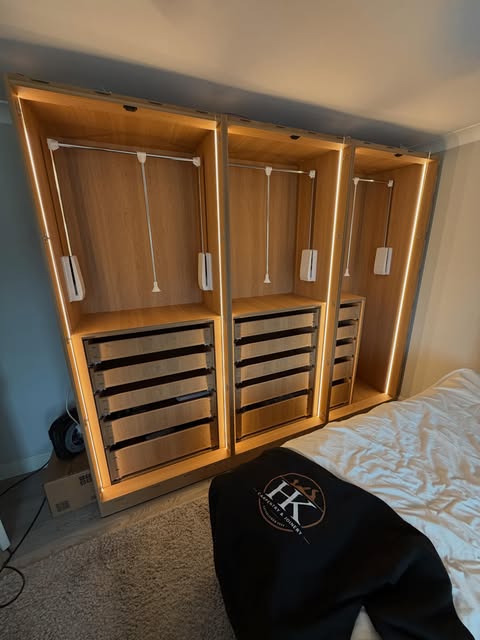 Fitted wardrobes with LED lighting, drawers and pull-down hanging rails